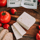 Slice of Tarina Telemea cheese made from matured buffalo milk in brine, showcasing its creamy texture and traditional appearance.